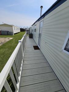 a wooden walkway next to a building at The Hive on The Chase Ingoldmells in Skegness