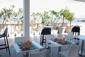 a restaurant with tables and chairs with a view of the ocean at Middle Town Palace in Tropea