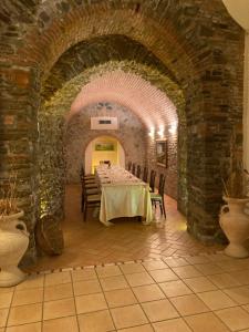 a dining room with a table and chairs in a building at Palazzo dei Poeti in Tursi +129 photos