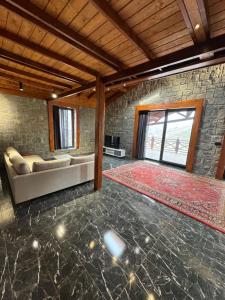 a living room with a couch and a rug at Copper villa in Macka