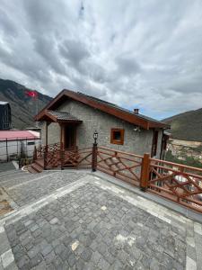 a small house with a wooden fence and a patio at Copper villa in Macka