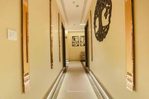 an empty hallway with a clock on the wall at FabHotel Vishesh Villas in New Delhi