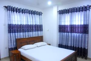 Letto o letti in una camera di Rathna Gems Halt