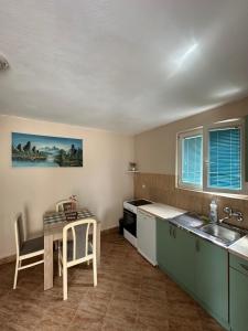 a kitchen with a sink and a table at Apartman Nina in Risan
