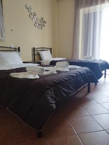 Posteľ alebo postele v izbe v ubytovaní KAMVISSIS HOTEL
