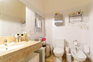 a bathroom with a sink and a toilet at Casa Cima Rio in Alcácer do Sal +16 photos