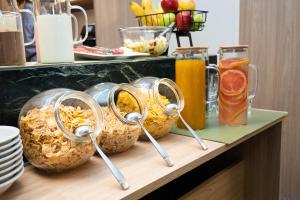 a buffet with bowls of food and drinks on a counter at Vain Boutique Hotel in Buenos Aires