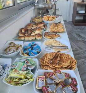 a buffet line with many different types of bread and pastries at Apartments Contessa in Ulcinj