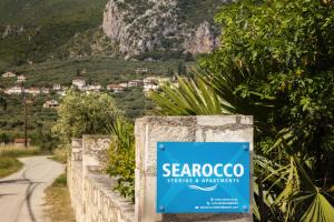 a sign for seacrocorongo stands on a fence at Searocco Studios & Apartments - Close to Alykes Center, by ZanteWize in Alykes