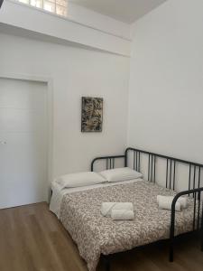 a bedroom with a bed in a white room at Maison Aida in Porto SantʼElpidio