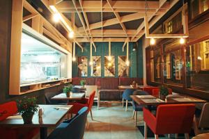 a restaurant with tables and chairs and a large window at Stay inn Hotel Gdańsk in Gdańsk
