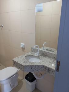 a bathroom with a sink and a toilet at Hotel CNP Brasil in Campo Novo do Parecis