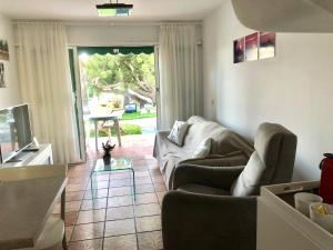 a living room with a couch and a tv at Bungalow Carmen in San Bartolomé