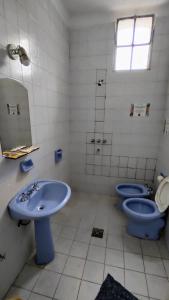 a bathroom with two blue toilets and a sink at Hostal Vampayá in Salta +96 photos