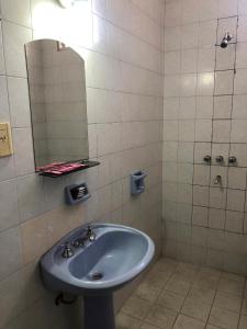 a bathroom with a sink and a mirror at Hostal Vampayá in Salta