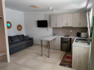 a kitchen with a couch and a table in a room at Voula Ilias Studios in Panormos Kalymnos