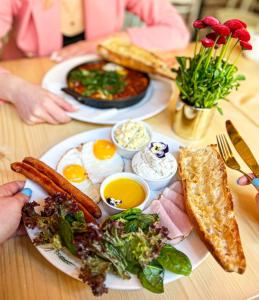 a table with two plates of breakfast food on it at Main Square Apartments in Krakow