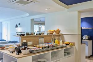 a kitchen with a buffet of food on a counter at Quality Hotel La Marebaudière Vannes Centre in Vannes