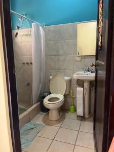 a bathroom with a toilet and a shower and a sink at Tucan Studio Ocotal in Coco