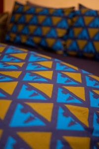 a blue and yellow pattern on a bed with pillows at Braemar Youth Hostel in Braemar