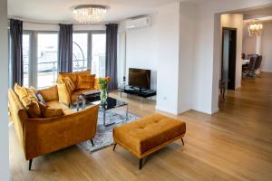 a living room with a couch and a table at LUXURIOUS APARTMENTS Cracow in Krakow