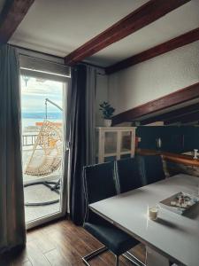 a dining room with a table and a view of the ocean at Knežević Apartments in Crikvenica