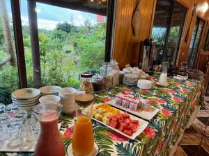 a table with food and fruit on it with a table cloth at Teanehi Bed & Breakfast in Hanga Roa