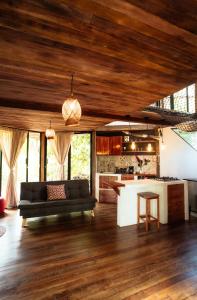 a living room with a couch and a kitchen at Almara House in El Valle