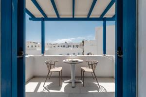 a table and chairs on a balcony with a view at Hotel Francesca in Agios Prokopios