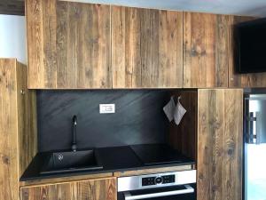 a kitchen with a sink and a stove at Rifugio Pirovano in Breuil-Cervinia