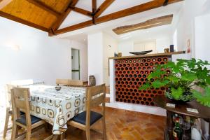 a kitchen with a table and chairs and a wine cellar at Salento in Alcácer do Sal