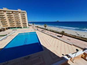 a view of a swimming pool and the beach at Apartamentos Ágata V.v. in La Manga del Mar Menor