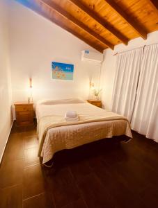 ein Schlafzimmer mit einem großen Bett in einem Zimmer in der Unterkunft Liwen Apartamentos de Playa in San Clemente del Tuyú