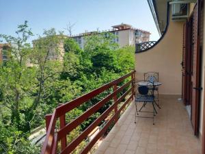 a balcony with a table and a chair on it at Piumahouse B&B in Catanzaro