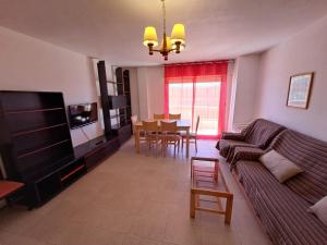 a living room with a couch and a table at Apartamentos Ágata V.v. in La Manga del Mar Menor
