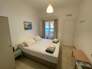 a bedroom with a bed with two towels on it at Annoula Studios and Apartments in Kardamaina
