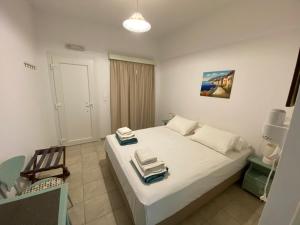 a bedroom with a white bed with two plates on it at Annoula Studios and Apartments in Kardamaina