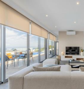 a living room with a couch and a table at Villa Serenity by Rentallido in Jardim do Mar