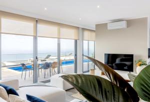 a living room with a view of the ocean at Villa Serenity by Rentallido in Prazeres