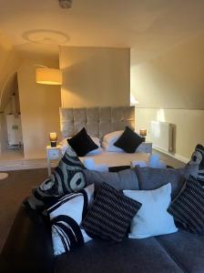 A bed or beds in a room at Balmaha Lodges and Apartments