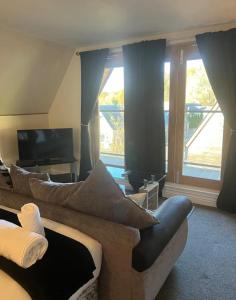 a living room with a couch and a television at Balmaha Lodges and Apartments in Balmaha