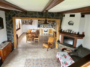 a living room with a table and a stone fireplace at Casa Muchia lui Gîrniță in Braşov