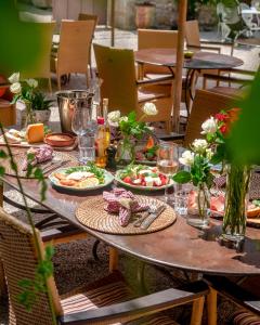 a wooden table with plates of food on it at Mas des Comtes de Provence in Tarascon