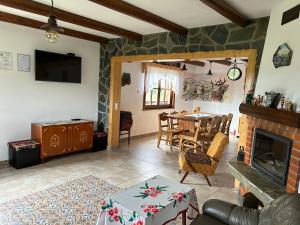a living room with a table and a fireplace at Casa Muchia lui Gîrniță in Braşov