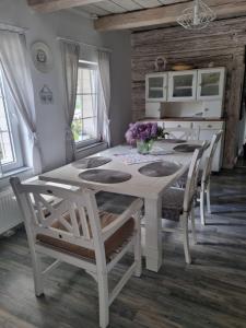 biała jadalnia z białym stołem i krzesłami w obiekcie Koperkowy Raj Beskid Wyspowy Domek Małopolskie w Laskowej