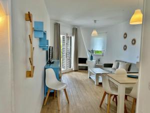 a living room with a table and a couch at Sa Posta in Cala en Forcat