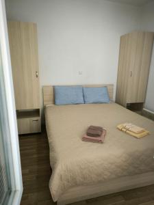 a bedroom with a bed with two towels on it at Ristevski Apartment in Bitola