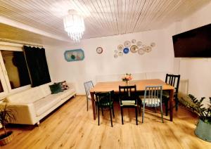 a living room with a table and chairs and a couch at Hermina Family Apartment Tatras in Ždiar +12 photos