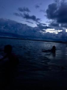 two people swimming in the water in the ocean at Waves cabana kalametiya in Ranna