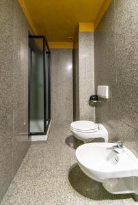 a bathroom with two toilets and a sink at Loft centro storico in Turin +21 photos